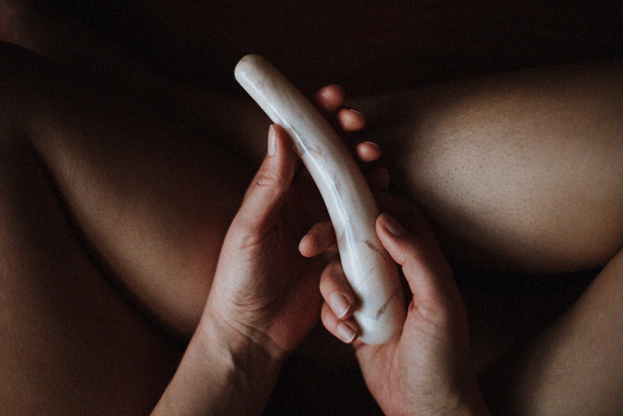 a woman holding a crystal pleasure wand